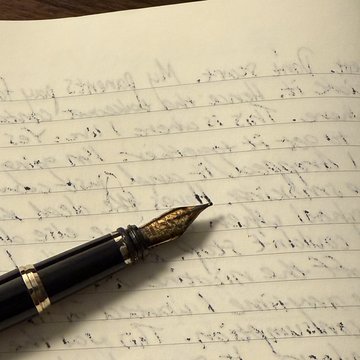 Fountain pen on a handwritten notebook page